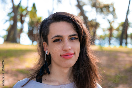 Young latin transgender woman wearing casual clothes happy face smiling looking at the camera. positive person.