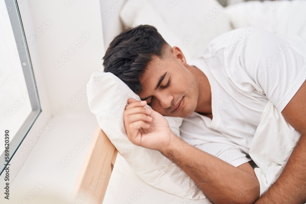 Young hispanic man lying on bed sleeping at bedroom Young hispanic man lying on bed sleeping at bedroom