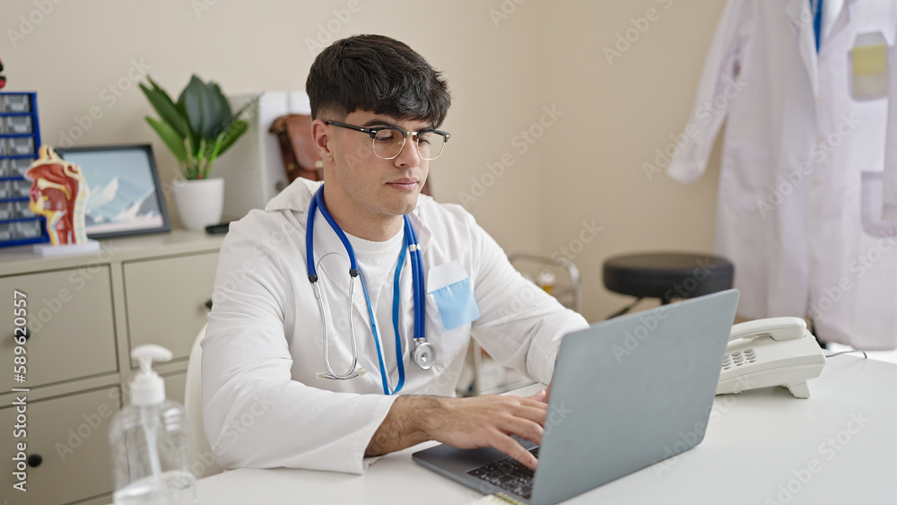 Young hispanic man doctor using laptop at clinic Young hispanic man doctor using laptop at clinic