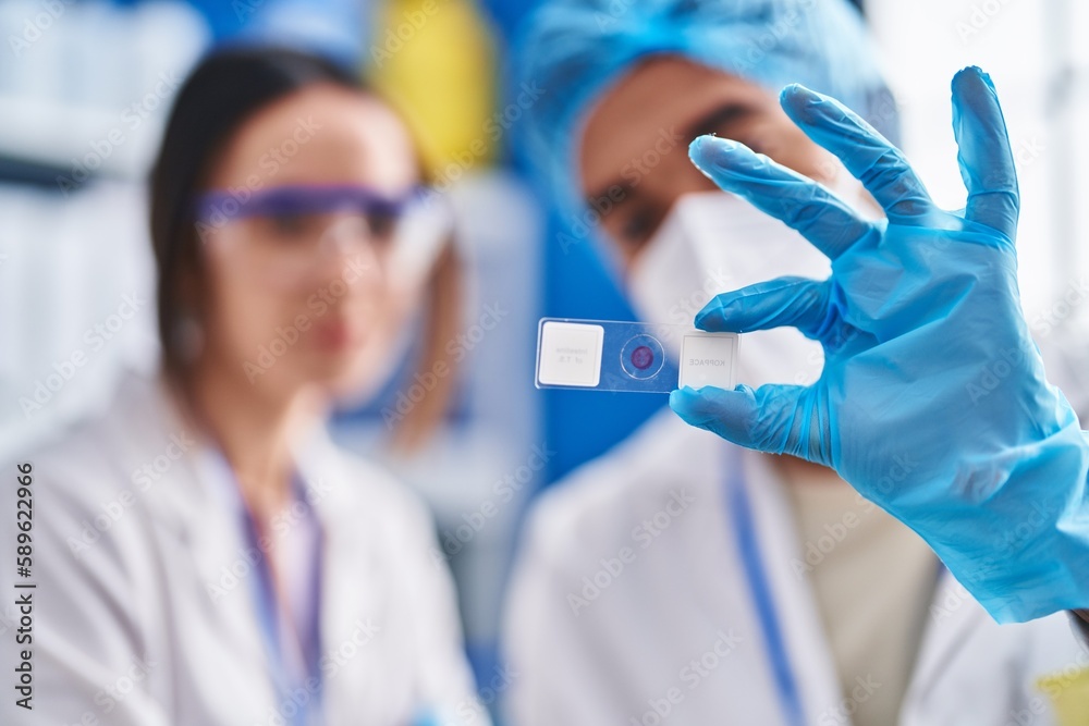 Man and woman scientists looking sample at street Man and woman scientists looking sample at street
