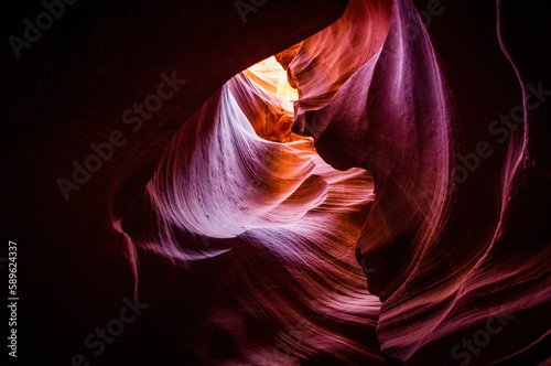 Antelope Canyon in the Navajo Reservation Page Northern Arizona. Famous slot canyon. Light showing off the glamorous detail of the ancient spiral rock arches. Multicolored texture, rock formation.