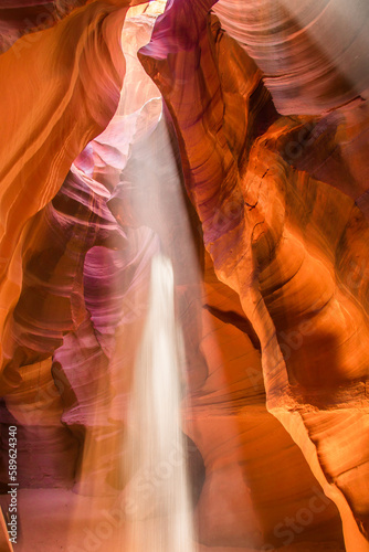 Upper Antelope Canyon in the Navajo Reservation Page Northern Arizona. Famous slot canyon. Falling sand is reflected in light beam. Falling sand in the light looks like a ghost.
