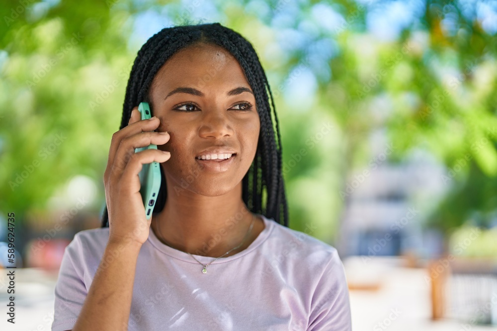 African american woman smiling confident talking on the smartphone at park African american woman smiling confident talking on the smartphone at park