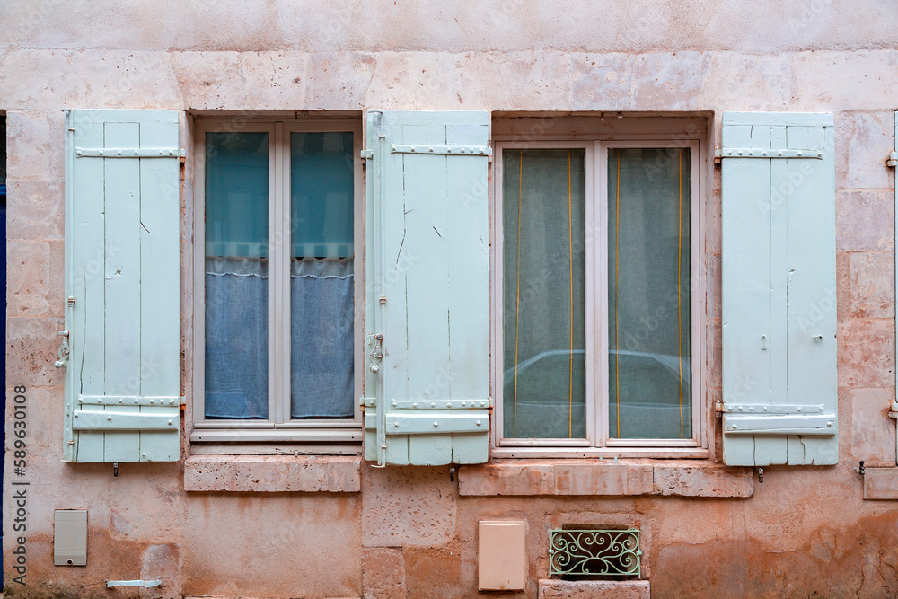 Windows with wooden shutters