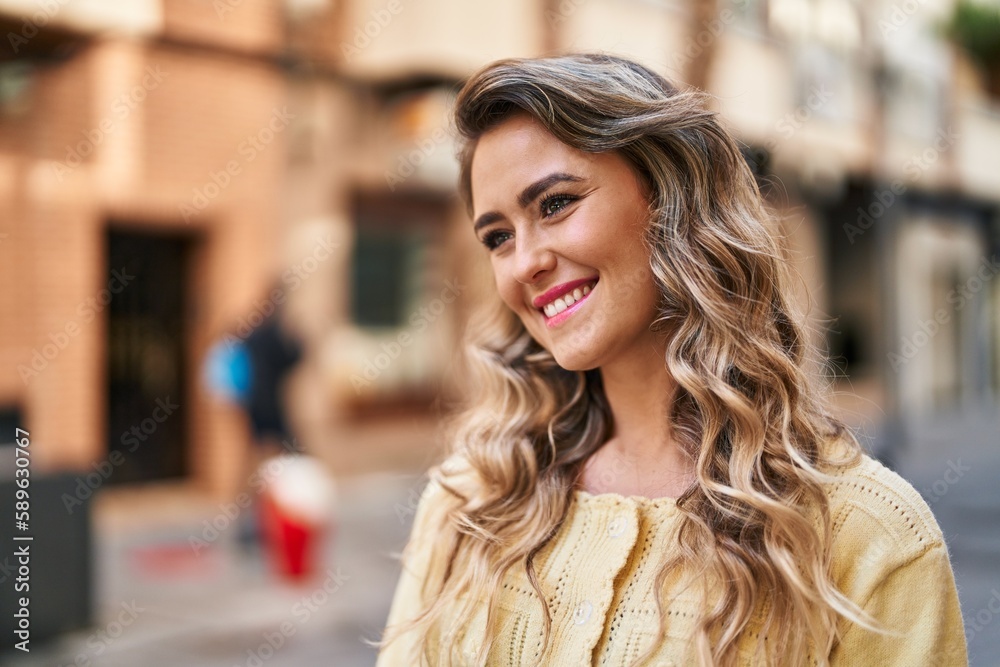 Young woman smiling confident looking to the side at street