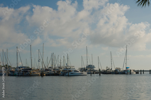 Bay Marina landscape with a Blue Sky on a sunny day. Sailboats in the background with calm blue water.