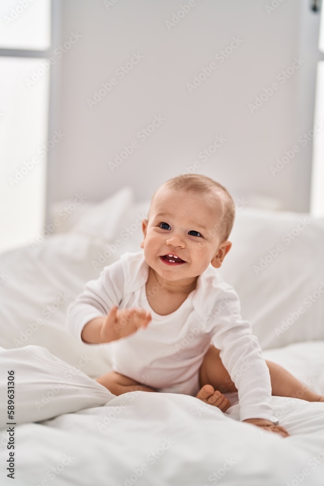Adorable toddler smiling confident crawling on bed at bedroom Adorable toddler smiling confident crawling on bed at bedroom