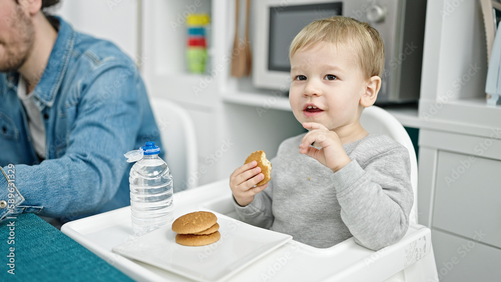 Father and son working and taking care child at dinning room Father and son working and taking care child at dinning room