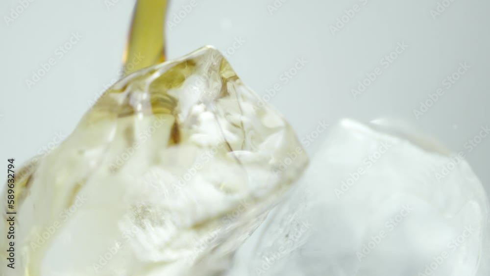 Cola being poured into a glass with ice Cola being poured into a glass with ice