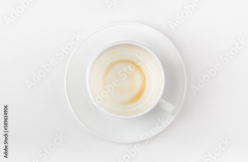A cup of coffee drunk on a white background. Top view.