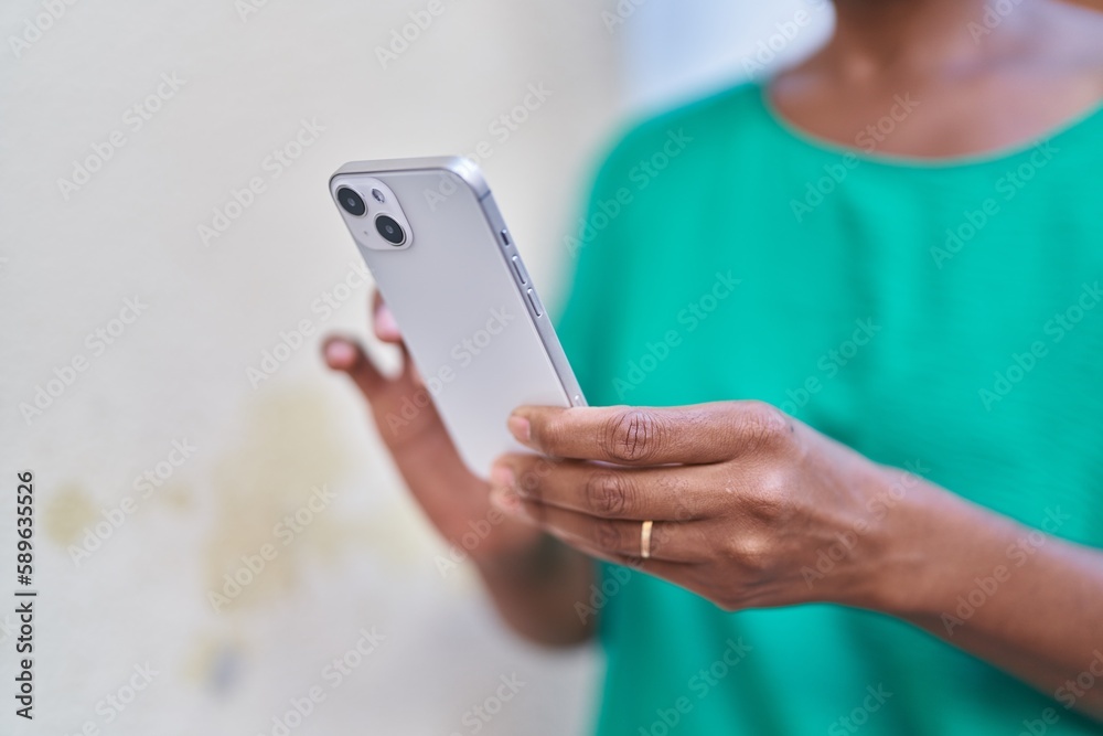 Middle age african american woman using smartphone at street Middle age african american woman using smartphone at street