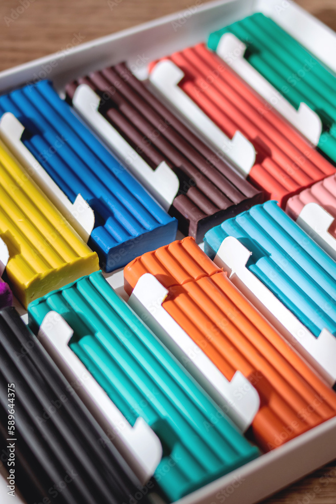 Multicolored plasticine on a wooden table closeup Multicolored plasticine on a wooden table closeup