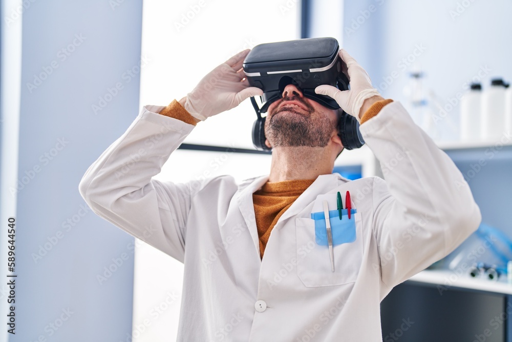 Young man scientist using virtual reality goggles at laboratory Young man scientist using virtual reality goggles at laboratory