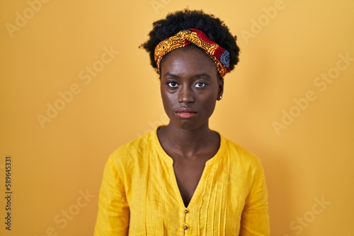 African young woman wearing african turban depressed and worry for distress, crying angry and afraid. sad expression.