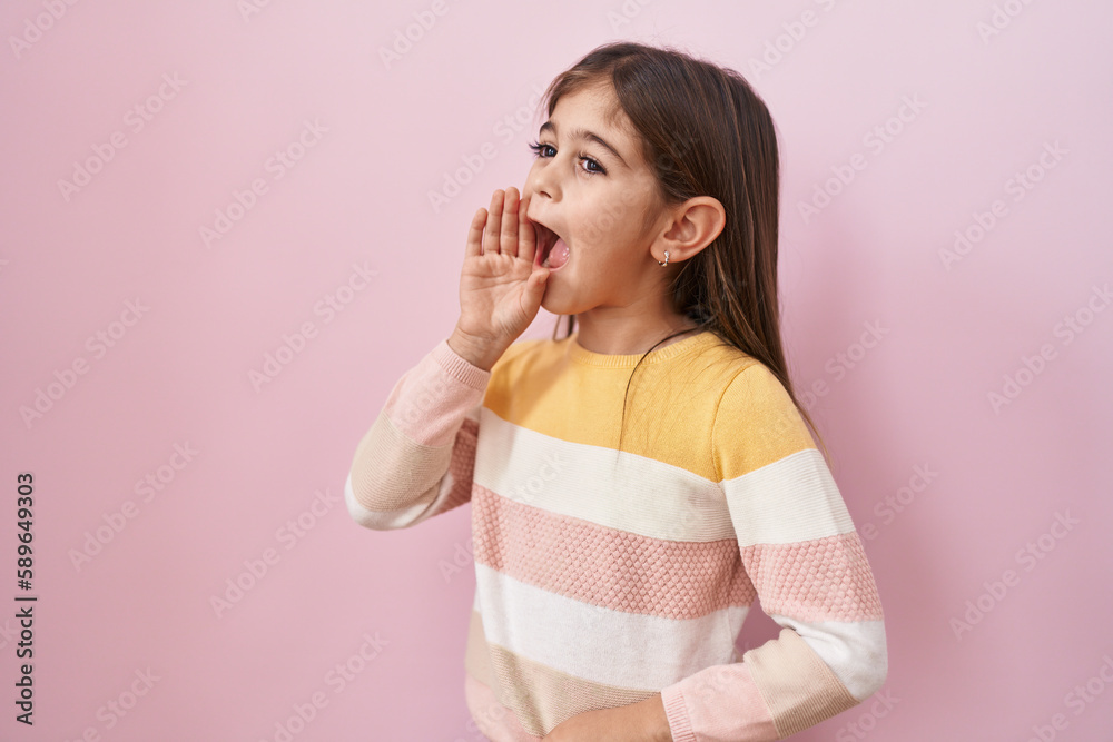 Little hispanic girl wearing sweater over pink background clueless and confused with open arms, no idea and doubtful face. Little hispanic girl wearing sweater over pink background clueless and confused with open arms, no idea and doubtful face.