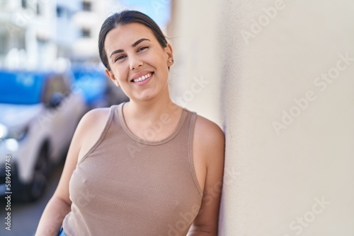 Young beautiful hispanic woman smiling confident standing at street