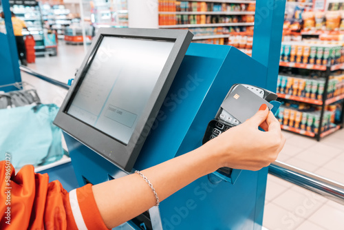 supermarkets automated self-service checkout system provides a seamless shopping experience, allowing customers to scan and pay with credit card for their items at their own pace. photo