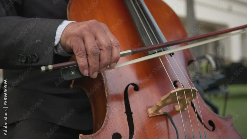 Close up of Playing the cello. Musician play music. Classical music playing stringed classical musical instruments talented people in art. Man playing outdoors. High quality 4k footage Close up of Playing the cello. Musician play music. Classical music playing stringed classical musical instruments talented people in art. Man playing outdoors. High quality 4k footage