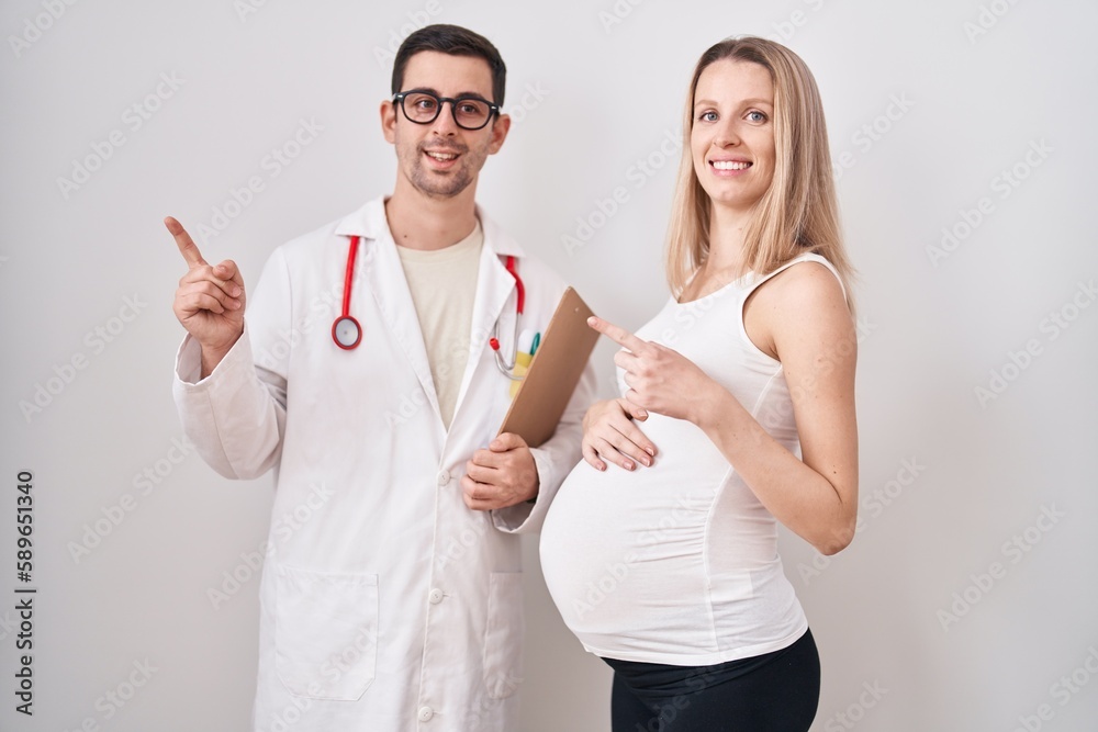 Young woman expecting a baby with doctor smiling happy pointing with hand and finger to the side