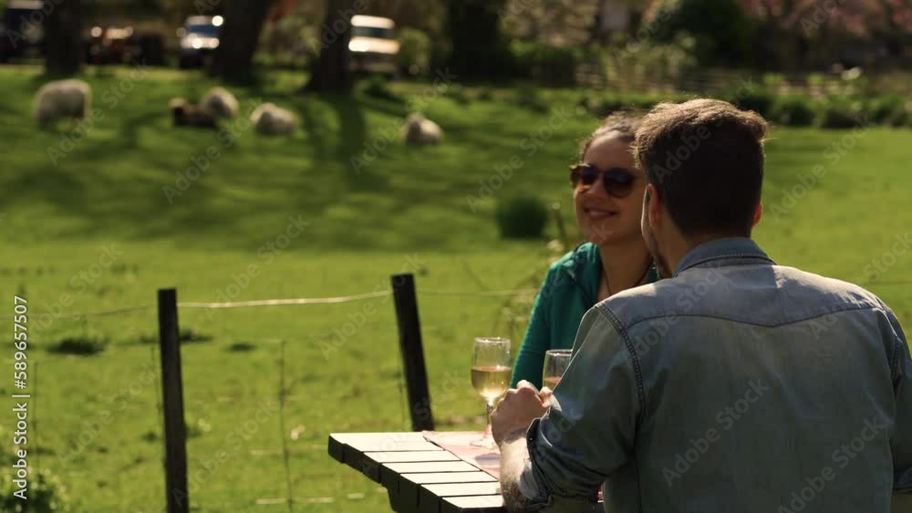 Young couple having lunch on campsite at the mountain, surrounded by sheep and nature Young couple having lunch on campsite at the mountain, surrounded by sheep and nature