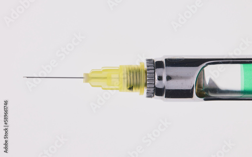 Steel dental syringe for local anesthesia, isolated on white. Carpool syringe for anesthesia in dentistry. Thin needle on a syringe for anesthesia in dentistry