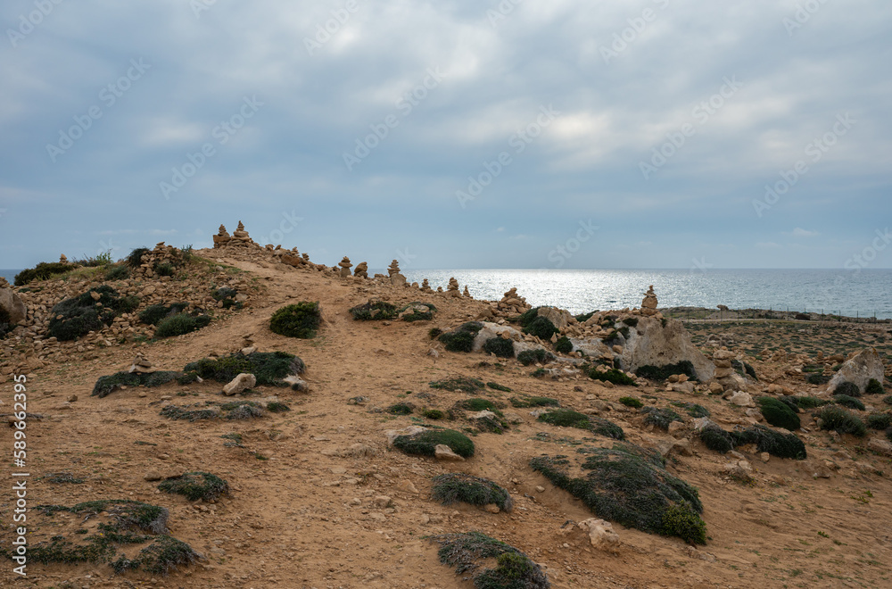 Landscape view over the sand and rocks at the coast of Paphos, Cyprus