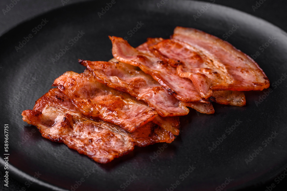 Delicious fresh fried bacon stripes with spices Delicious fresh fried bacon stripes with spices