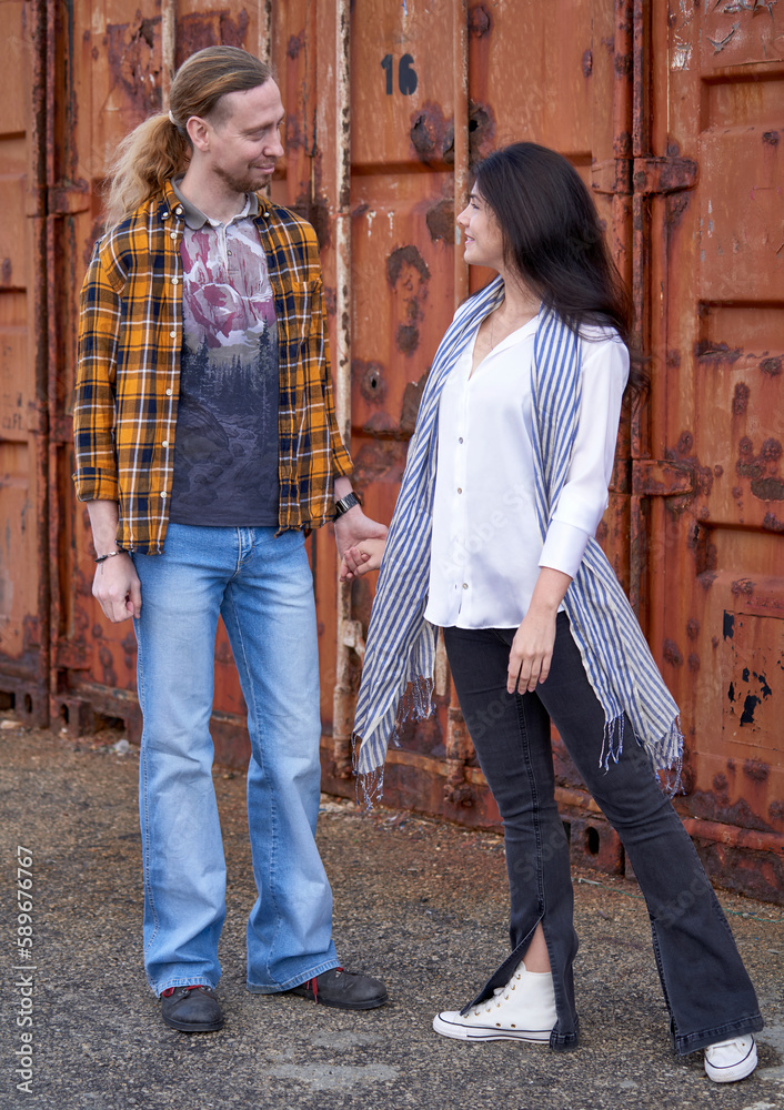 elegant-young-couple-posing-with-the-old-rusty-container-at-the