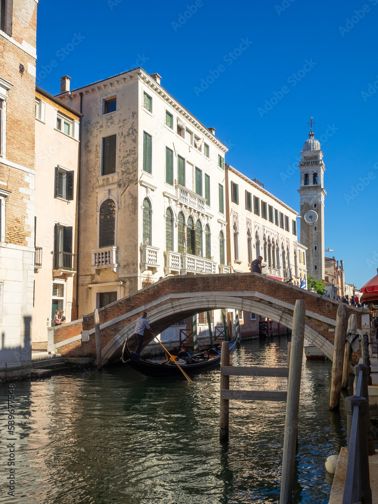 Naklejka premium A gondola passes under a bridge in Rio di San Lorenzo, Venice