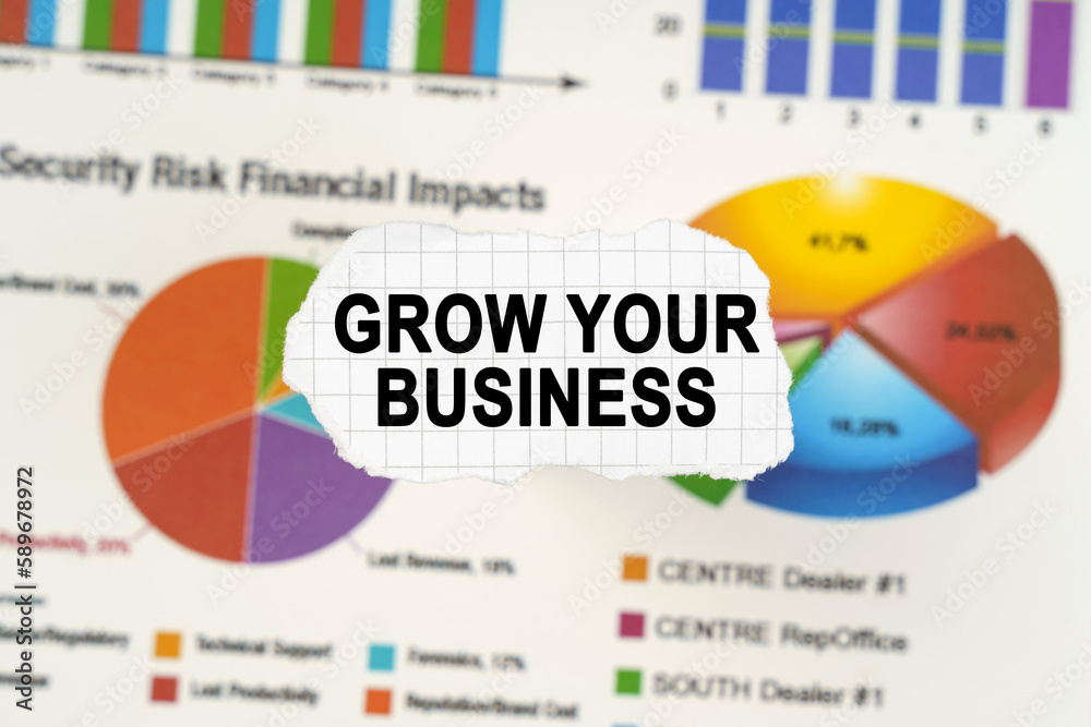 Φωτογραφία On diagrams and graphs lies torn paper with the inscription - Grow your business