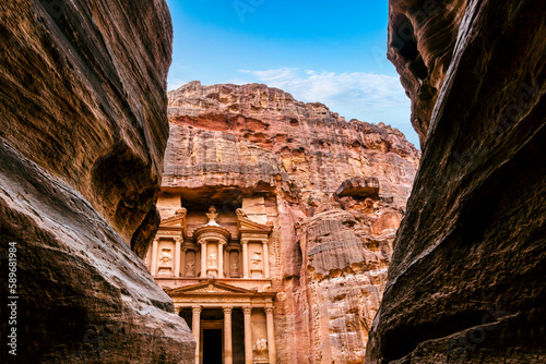 The ancient Treasury Building or Al Jhazneh, seen from the Siq, a narrow gorge through the sandstone canyon in Petra, Jordan. 