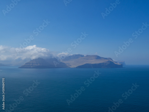 Eysturoy island and Gjogv hamlet in the horizon, seen from Kalsoy Kallur lighthouse hiking path