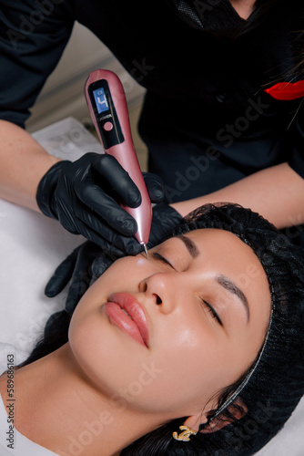 Procedure of the Temperature Measurement Face Skin. Skin Augmentation Procedure. Beauty Procedures. Plastic Surgery. Cosmetologist In Medical Gloves, Carefully and Slowly Working