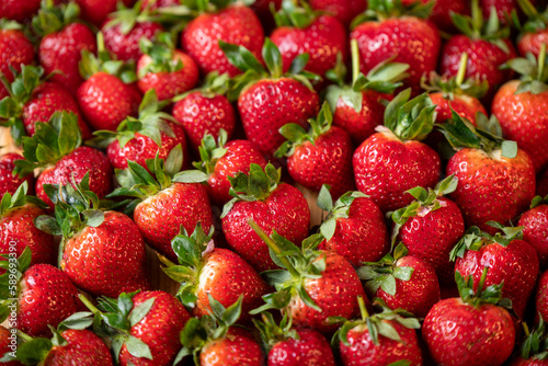 Fresh strawberries with green leaves  strawberry background