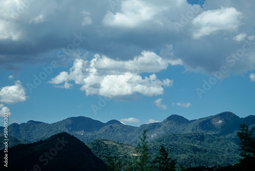 clouds over mountain in sunny day
