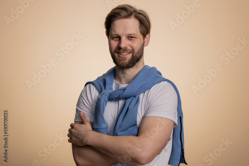 Portrait of happy calm stylish man smiling friendly, glad expression looking away dreaming resting, relaxation feel satisfied concept good news, celebrate win. Guy on studio beige background indoor