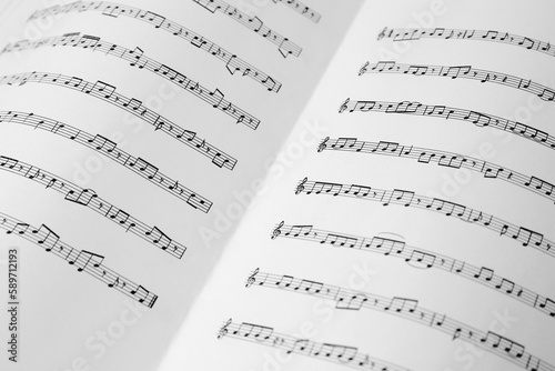 Sheet music book as background, closeup view