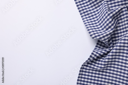 Blue checkered tablecloth on white background, top view