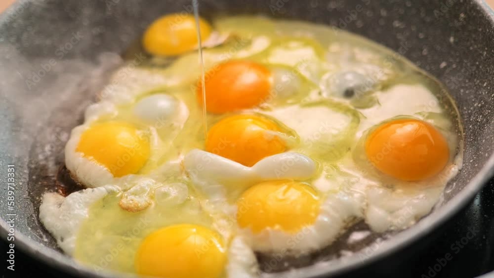 Fried eggs for breakfast.protein breakfast in sunflower oil.process of preparing breakfast. scrambled eggs.Frying pan with eggs in the morning sunlight close-up. 4k footage Fried eggs for breakfast.protein breakfast in sunflower oil.process of preparing breakfast. scrambled eggs.Frying pan with eggs in the morning sunlight close-up. 4k footage
