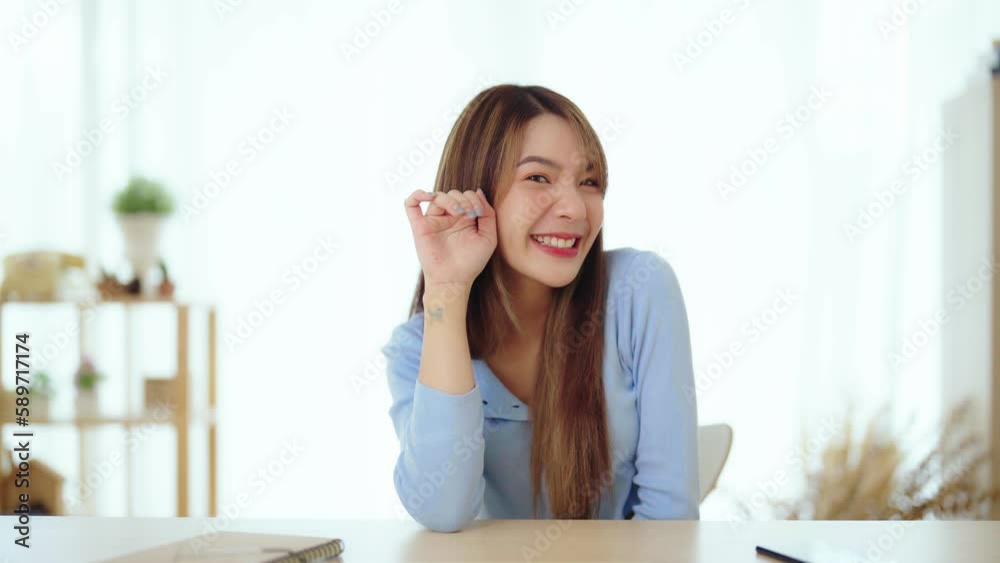 Happy young asian woman blogger applicant teacher sit at home office look at camera doing online job interview during video chat conference call record vlog teaching on webinar meeting Happy young asian woman blogger applicant teacher sit at home office look at camera doing online job interview during video chat conference call record vlog teaching on webinar meeting
