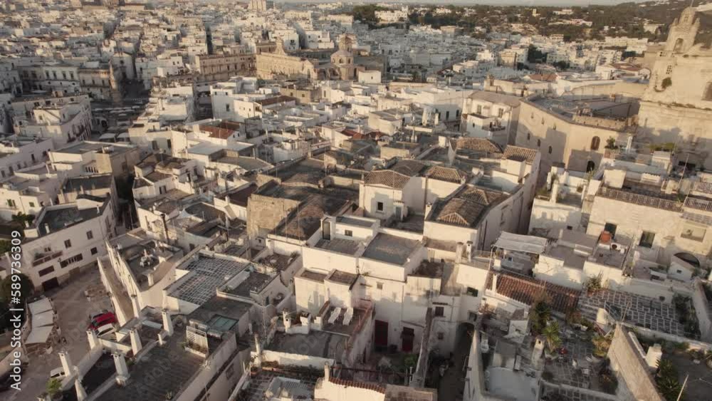 Drone flying in circulair motion with the camera tilting slowly upwards over the old white city Ostuni in the south of Italy in 4k Drone flying in circulair motion with the camera tilting slowly upwards over the old white city Ostuni in the south of Italy in 4k