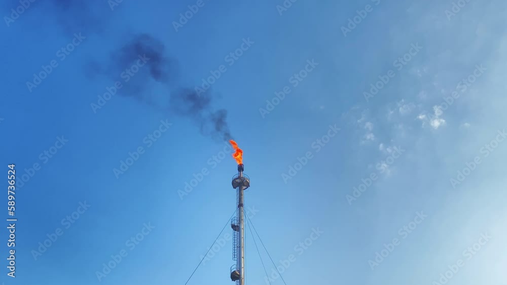 Static wide view of burning flare stack flame at refinery Oil industry Static wide view of burning flare stack flame at refinery Oil industry