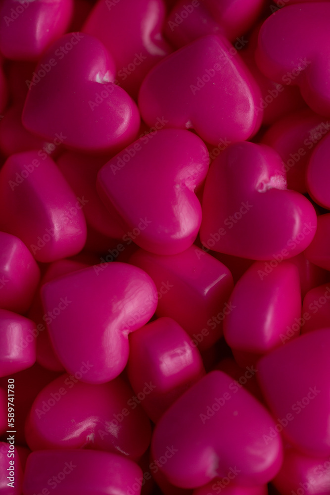 Dark pink heart sugar sprinkles texture extreme close up Dark pink heart sugar sprinkles texture extreme close up