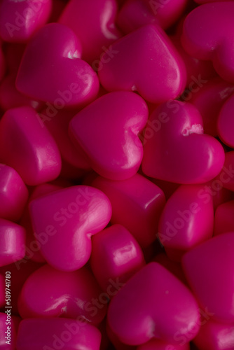 Dark pink heart sugar sprinkles texture extreme close up © Jennifer