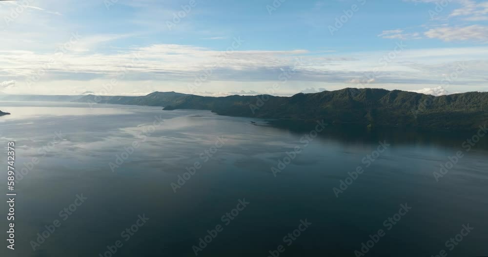 Aerial drone of lake Toba among the mountains with rainforest. Sumatra, Indonesia. Aerial drone of lake Toba among the mountains with rainforest. Sumatra, Indonesia.
