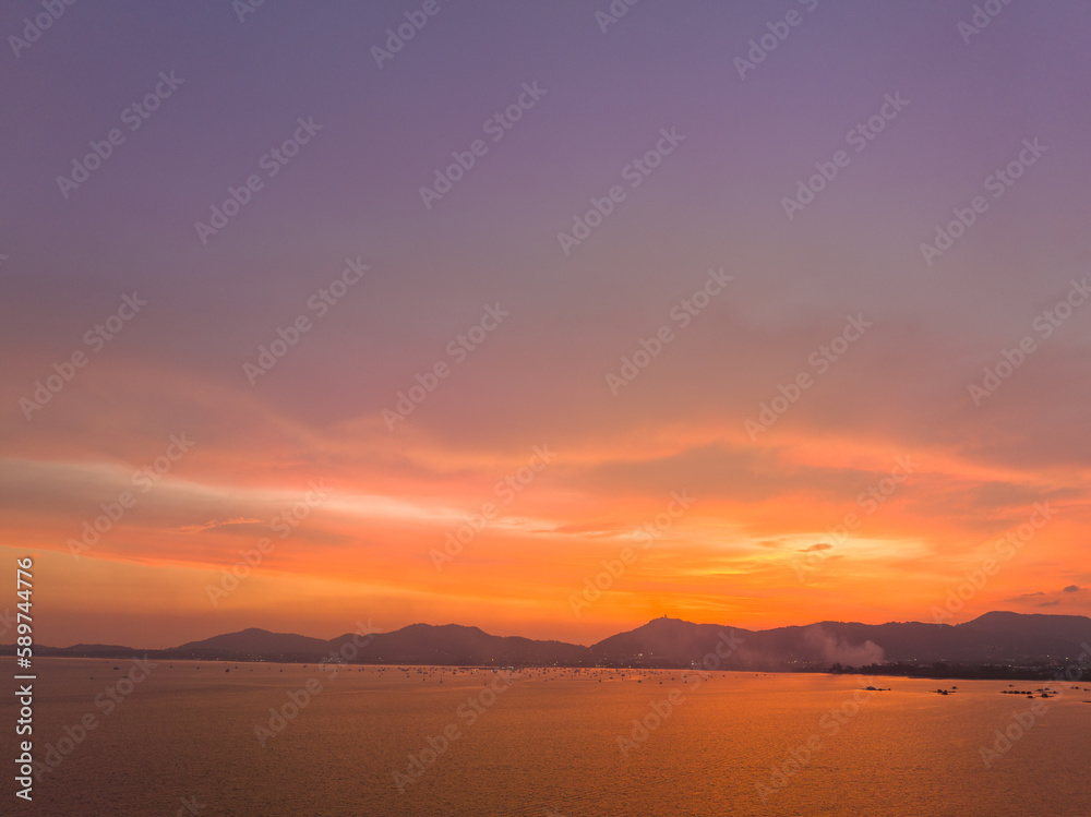 .aerial view stunning sky in sunset above the sea..colorful cloud in bright sky of sunset above the ocean at Khao Khad Phuket. .Majestic sunset or sunrise landscape Amazing light of nature 