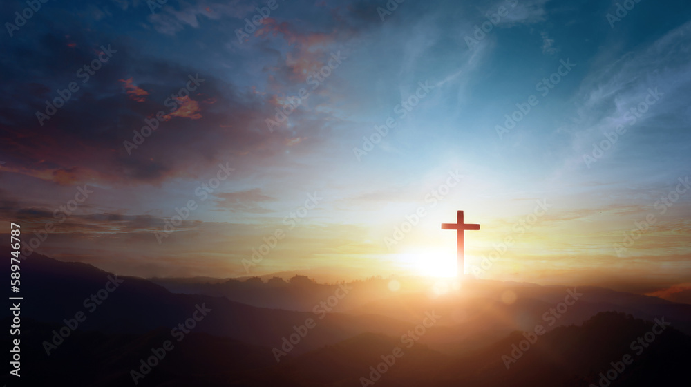 The crucifix symbol of Jesus on the mountain sunset sky background