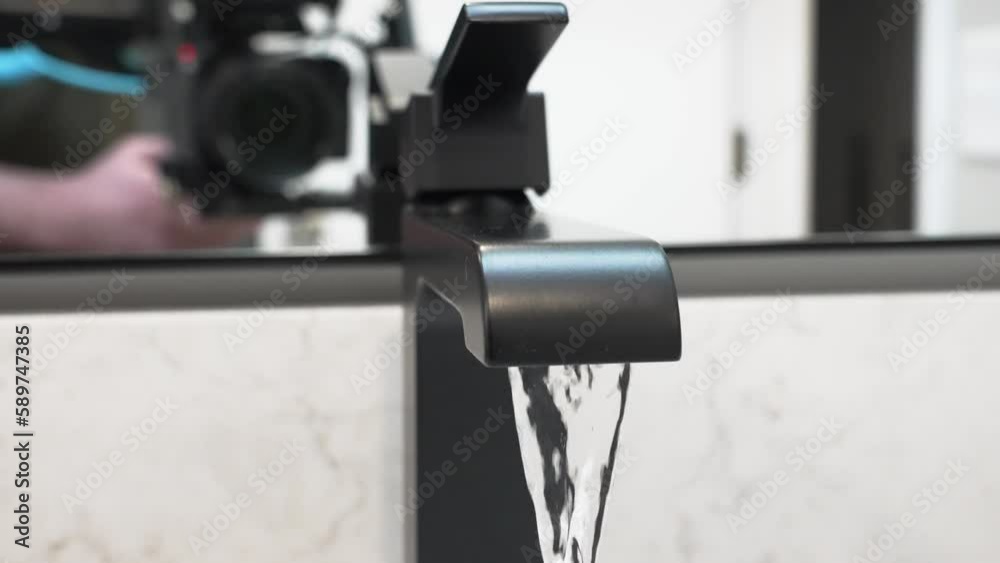Extreme close up of a faucet with water spout. Extreme close up of a faucet with water spout.