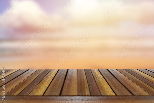 Teak wooden table top setting against sea wave light blurred background. 