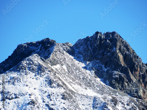 First snow on the rocky mountain peak Piz Sarsura (3175 m) in the Albula Alps and above the alpine valley Val Grialetsch, Zernez - Canton of Grisons, Switzerland (Kanton Graubünden, Schweiz) © Mario